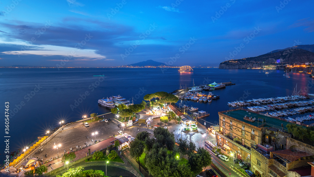 The blue hour in marina piccola di sorrento with vesuvius in the background and a cruise ship