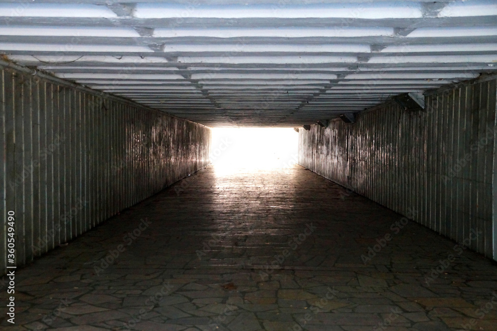 underground pedestrian tunnel, daylight at the end of the tunnel underground pedestrian tunnel, daylight at the end of the tunnel