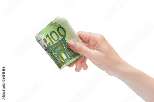 Folded euro bills in woman's hand. Isolated on white.