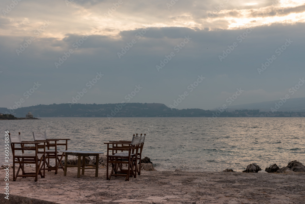 Small tables of a restaurant by the Greek sea Small tables of a restaurant by the Greek sea