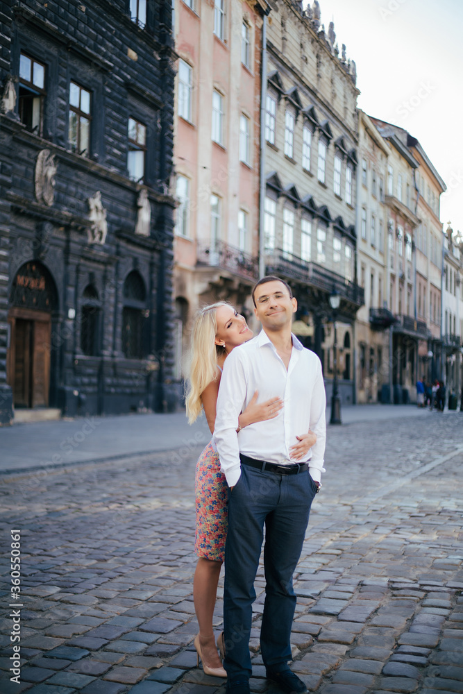 beautiful couple on city background posing, full height