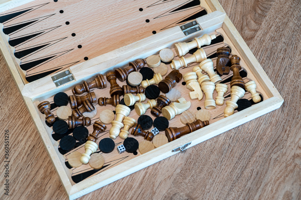 Checkers and chess are randomly mixed scattered in a box