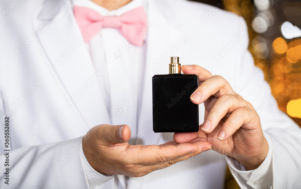Man scent perfume. Perfume or cologne bottle. Fashion cologne bottle. Rich  man prefers expensive fragrance smell. Fragrance smell. Male fragrance,  perfumery, cosmetics. Smell perfume. Expensive suit Stock Photo | Adobe  Stock