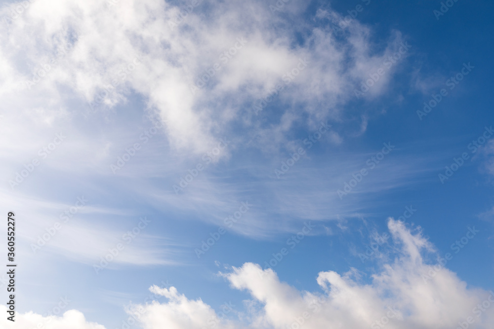 Mix of hard and soft white clouds in blue sky Mix of hard and soft white clouds in blue sky