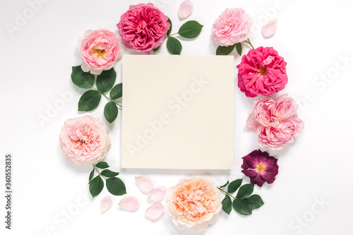 Empty card for logo or congratulation with pastel pink garden roses. Branding mock up, holiday marketing concept.