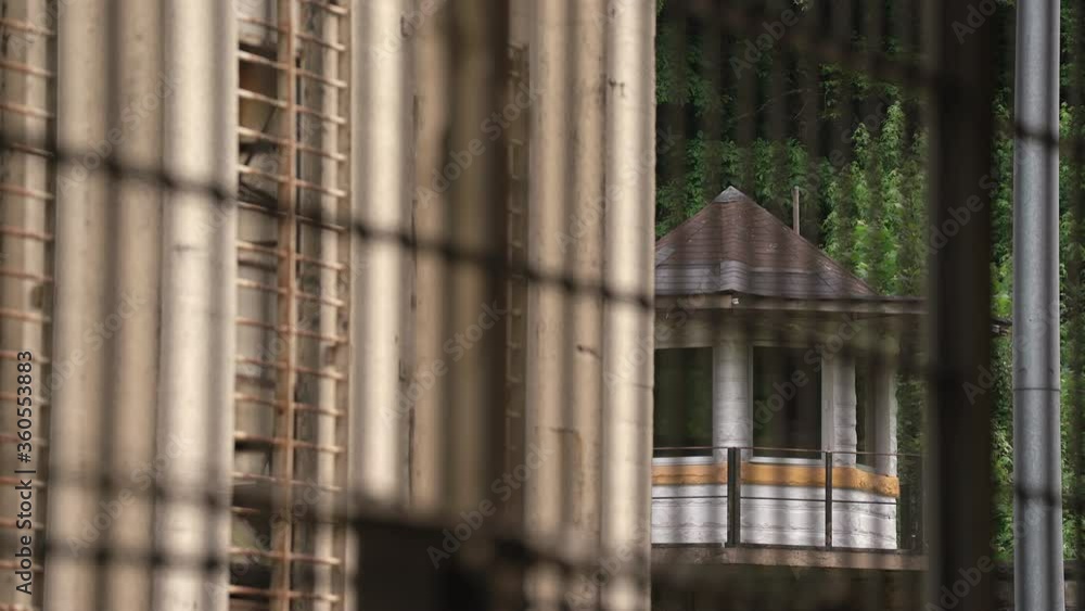 Prison Guard Tower and Razor Wire on Jail Wall Prison Guard Tower and Razor Wire on Jail Wall