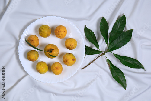Wallpaper Mural Fresh tasty eggfruit with leaves on a white bowl Torontodigital.ca