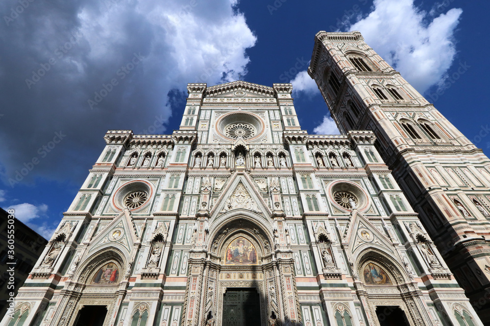 Santa Maria in Fiore facade with Giotto bell tower, wide angle shot from below in the sky, Florence, Italy, word heritage touristic site