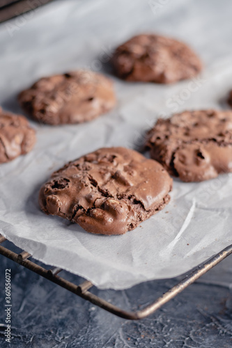 Choco chip cookies on unbleached parchment paper. Cookies with chocolate on baking paper. Close up. Copy space