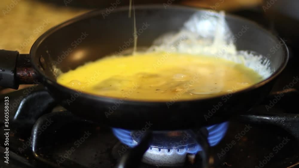 Adding eggs to pan Adding eggs to pan