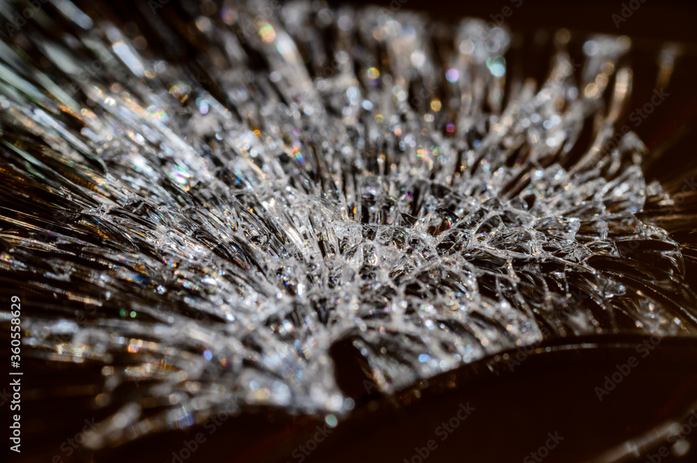 Cracks on the glass of a mobile phone in detail. Cracks on the glass of a mobile phone in detail.