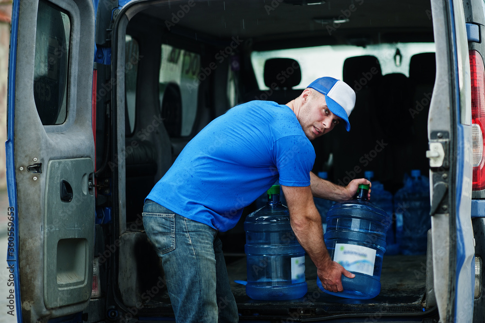 Delivery man in front cargo van delivering bottles of water. Delivery man in front cargo van delivering bottles of water.
