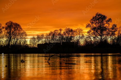 Sunset on the lake in the village © Milyakhovskiy