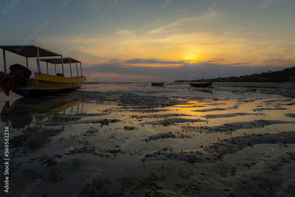 Boats stranded on sand at sunset, Nusa Ceningan, Bali