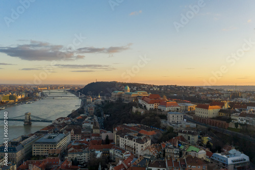 Aerial drone shot of Buda castle on hill during Budapest sunset hour © Davidzfr