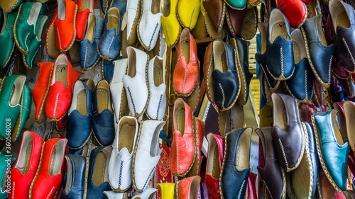 Traditional colorful shoes in the bazaar or market at Gaziantep City, Turkey. Colorful shoes texture pattern background. Variety of beautiful colorful leather shoes in India.
