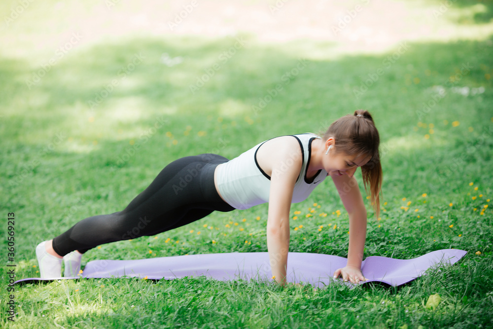 Fototapeta premium A young woman is engaged in sports, a healthy lifestyle,