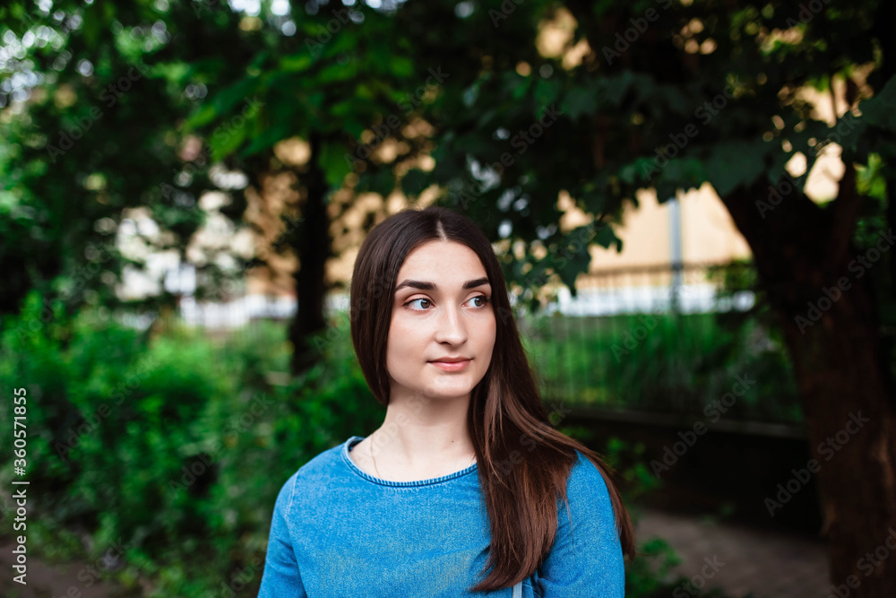 Portrait of a smiling european woman walking on a city street. Portrait of happy smiling woman standing on the square on sunny summer or spring day outside. Portrait of a smiling european woman walking on a city street. Portrait of happy smiling woman standing on the square on sunny summer or spring day outside.
