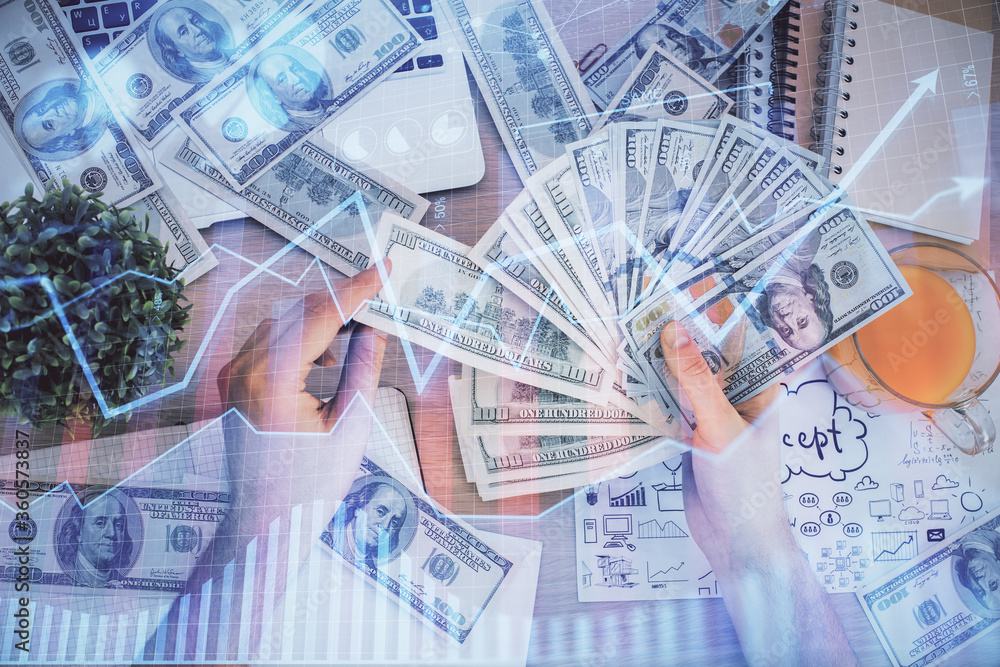 Multi exposure of financial graph drawing hologram and USA dollars bills and man hands. Analysis concept. Multi exposure of financial graph drawing hologram and USA dollars bills and man hands. Analysis concept.