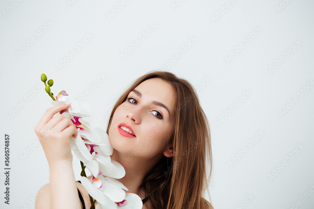 woman holding an orchid on a white background woman holding an orchid on a white background