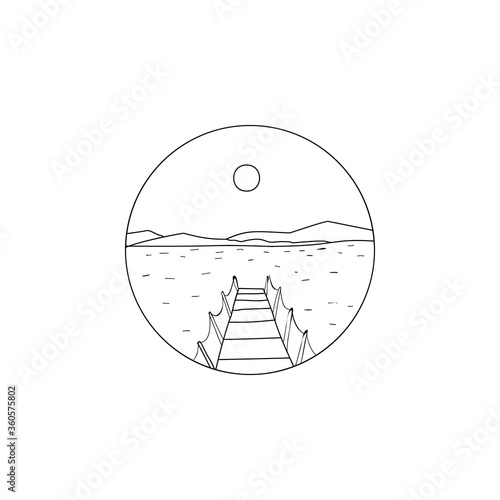 Landscape with a pier going into the water against the backdrop of mountains and the sun inside the circle