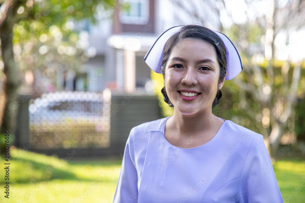 Asia woman working in nursing home. Beautiful young nurse woman wearing uniform standing outdoors. Asia woman working in nursing home. Beautiful young nurse woman wearing uniform standing outdoors.