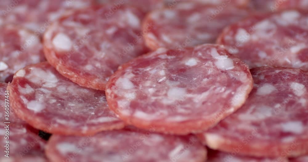 Cut into pieces salami slowly rotates. Cut into pieces salami slowly rotates.