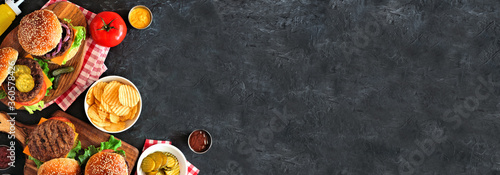 Panel kuchenny z motywem BBQ hamburger corner border. Top down view table scene over a dark slate banner background. Copy space.