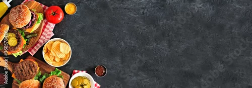 Panel kuchenny z motywem BBQ hamburger corner border. Top down view table scene over a dark slate banner background. Copy space.