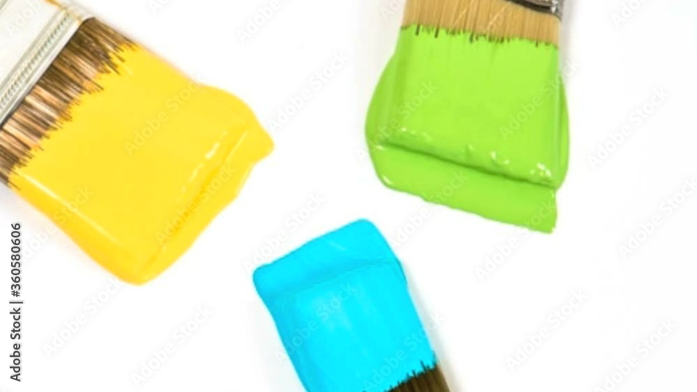 Three paint brushes with wet paint. Three paint brushes with wet paint.