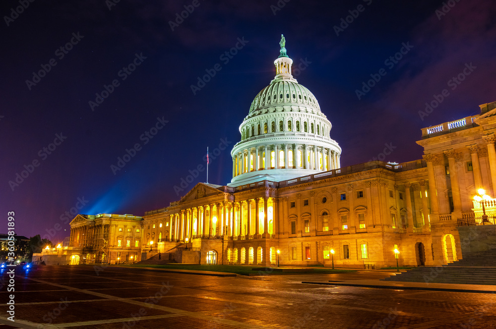 Architectural light illuminate mall and marble dome on the east side entrance of United States capitol building at night in Washington DC in summer