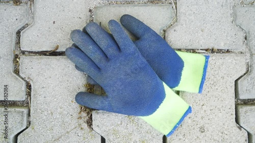 Construction protective working gloves on the ground, static shot.