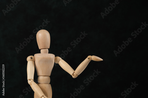 Handcrafted wooden man figure mannequin model dummy doll on background. Copy space.