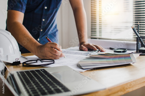 creative designer check and write on paper on table