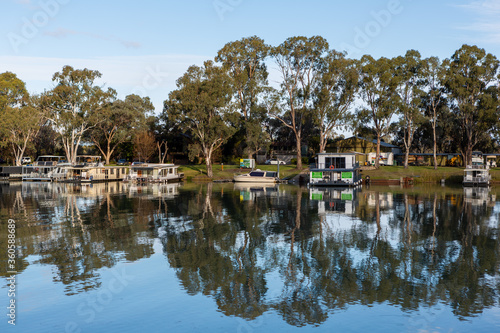 Obraz na płótnie The reflection of house boats and tree on a calm river murray located in the river land at Berri South Australia on 20th June 2020 w salonie