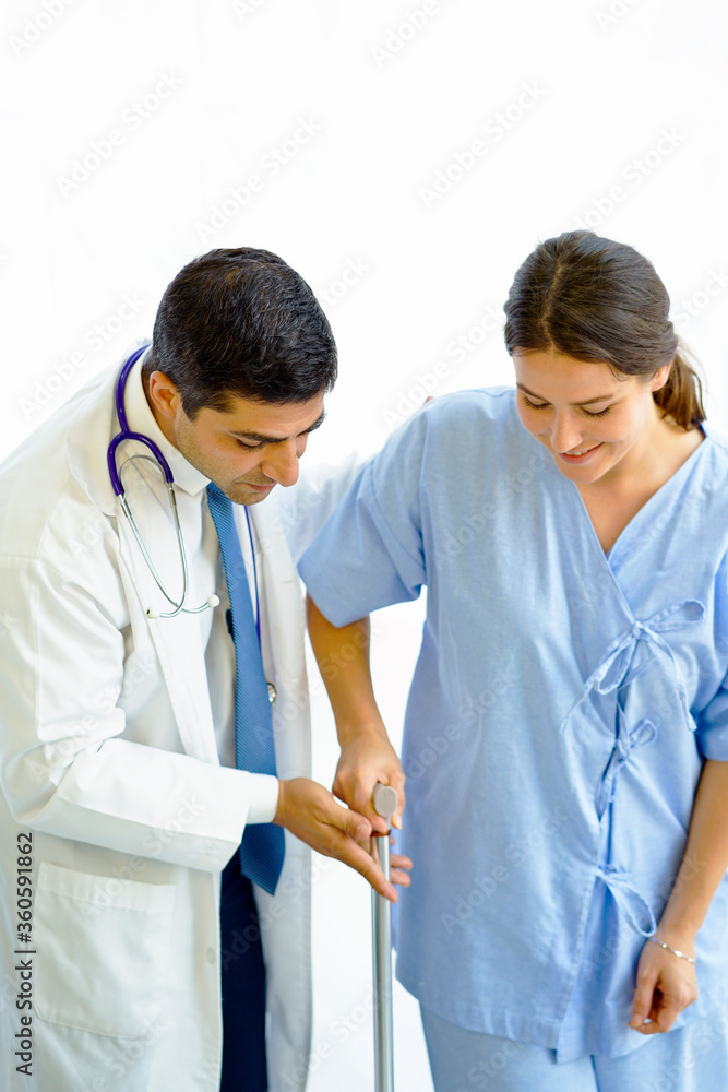 The doctor helped the female patient to walk on crutches. The doctor helped the female patient to walk on crutches.