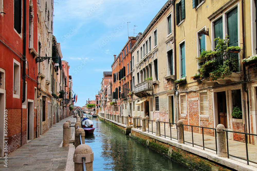Row of houses along narrow canal in Venice, Italy