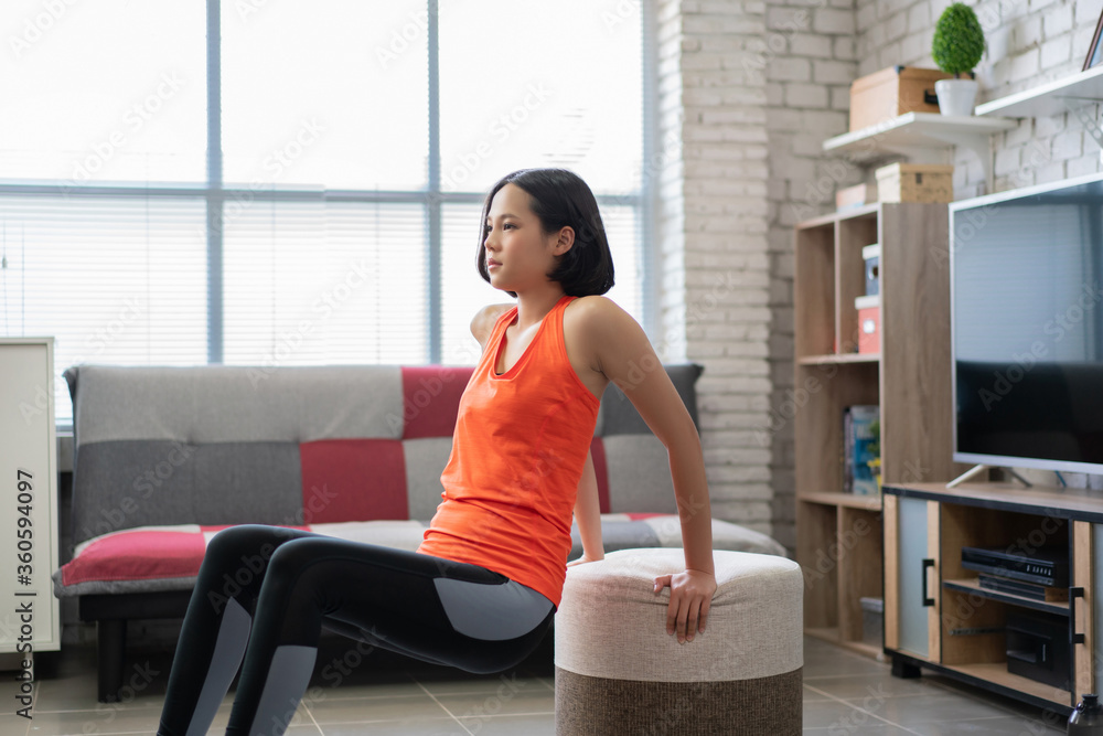 Beautiful asian woman exercises at home She exercises on her arms. Beautiful asian woman exercises at home She exercises on her arms.