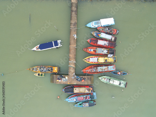 Aerial shot of tourism and fishing boats anchored at a jetty