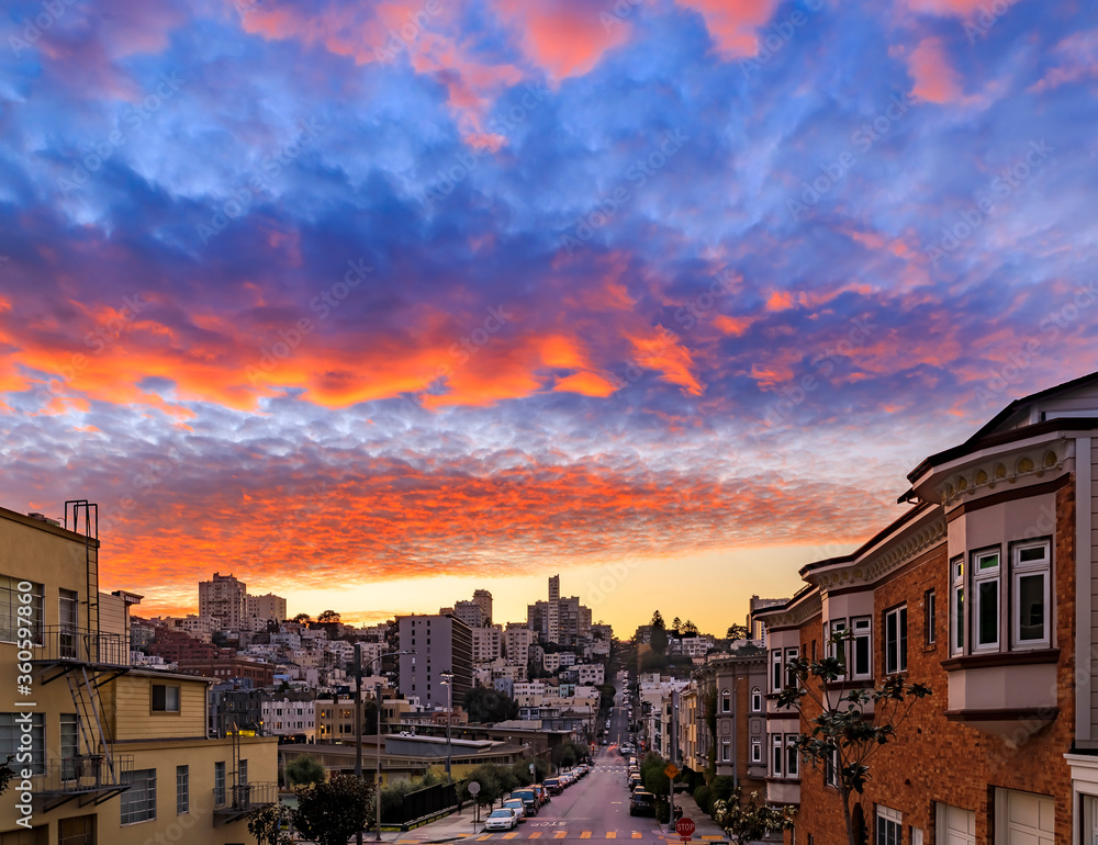 High angle view of homes on the famous crooked Lombard Street, San Francisco California with fiery skies at sunset