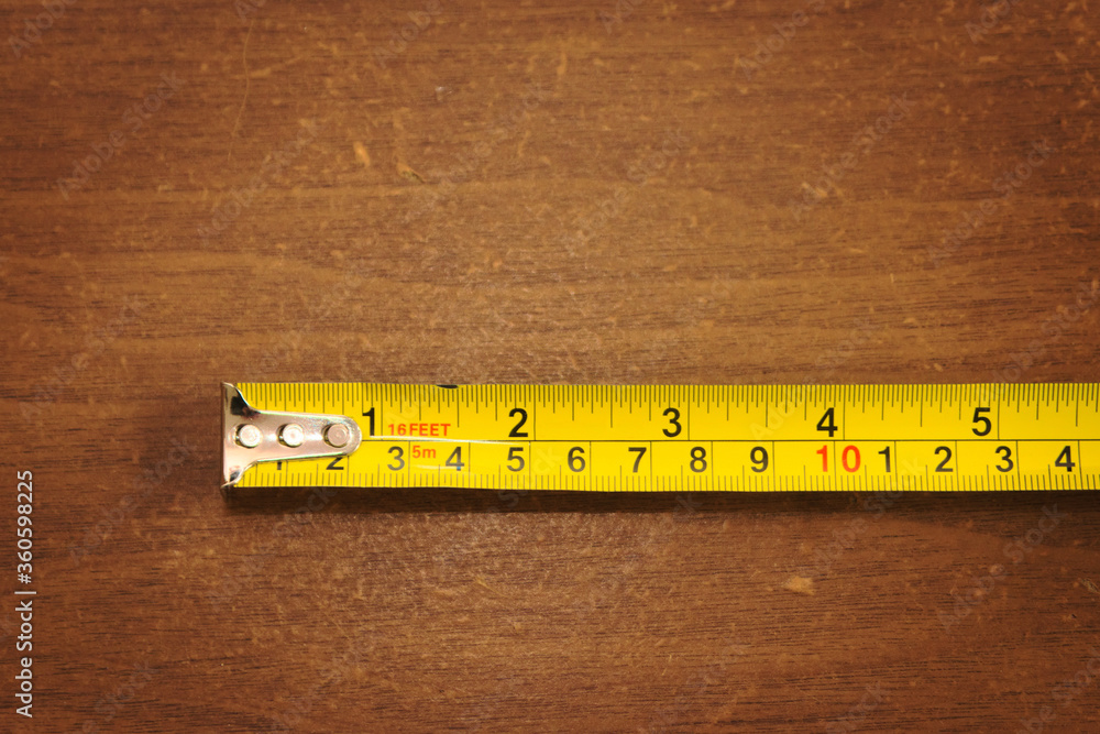 Yellow metallic measuring tape. Macro close up. Yellow metallic measuring tape. Macro close up.