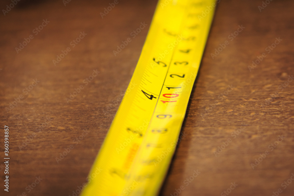 Yellow metallic measuring tape. Macro close up. Yellow metallic measuring tape. Macro close up.