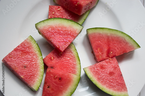 Close up of water melon bites on a white plate, summer fruit