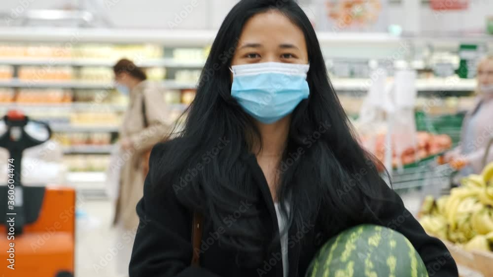People buy fruits in supermarket wearing masks during coronavirus outbreak. People buy fruits in supermarket wearing masks during coronavirus outbreak.