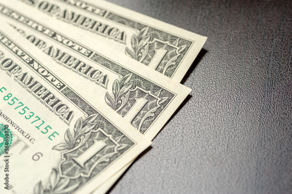 Paper dollar bills are lying on the table