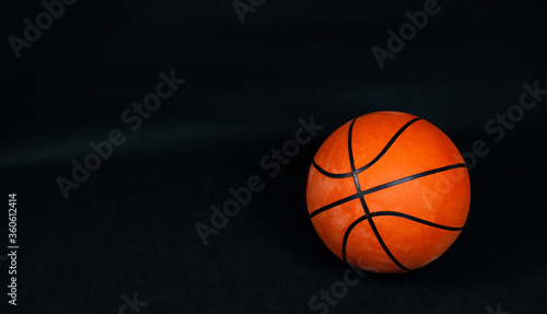 Basketball ball on a black background © Zhanna