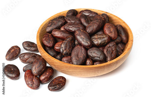 peeled cocoa beans in the wooden bowl, isolated on white background