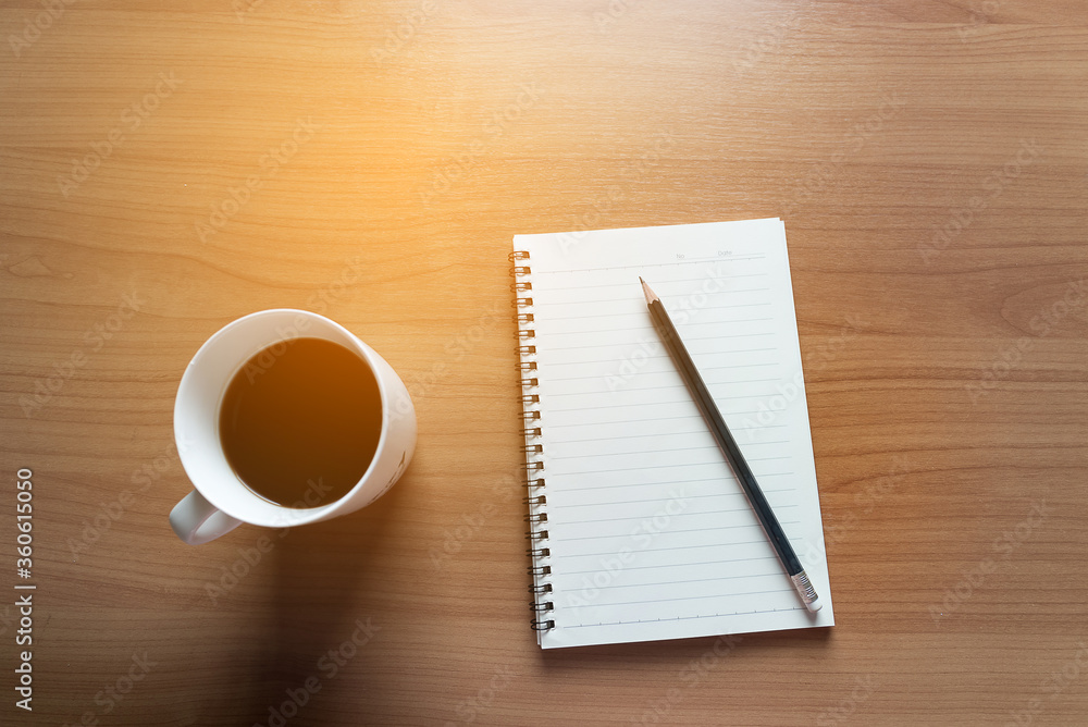 Travel Planning on Calendar and use post-it for note with a cup of coffee on a wooden table Travel Planning on Calendar and use post-it for note with a cup of coffee on a wooden table