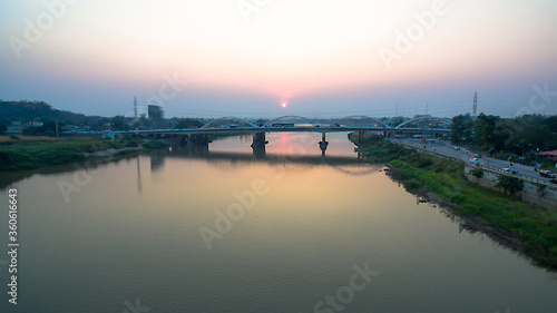 .scenery sunset above Dechatiwong bridge across Chao Phraya river in Nakornsawan province Thailand © Narong Niemhom