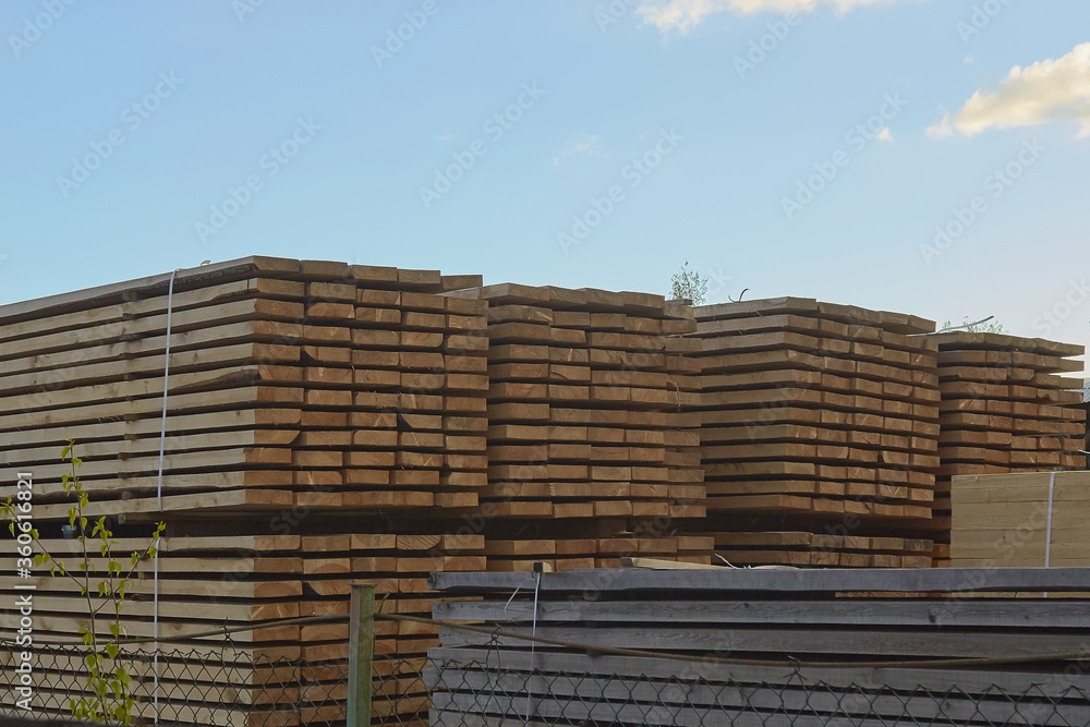 Pallet storage of wood in the company in the industrial zone of the city on a spring day Pallet storage of wood in the company in the industrial zone of the city on a spring day